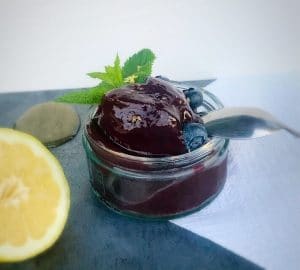 Lemon and Blueberry sorbet garnished with lemon zest, blueberries and mint leaves.