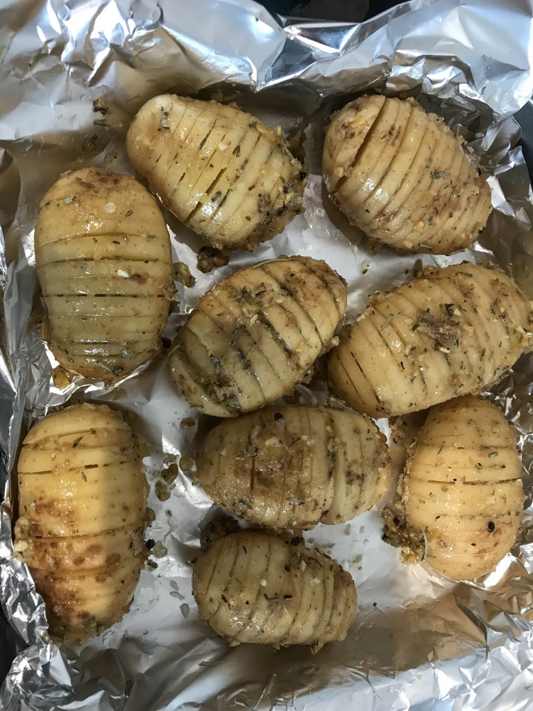 Process shot of rosemary hassleback potatoes