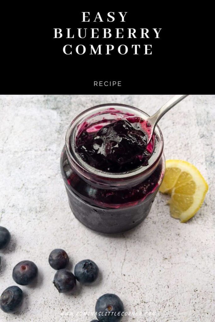 Blueberry compote with scattered blueberries and a lemon wedge