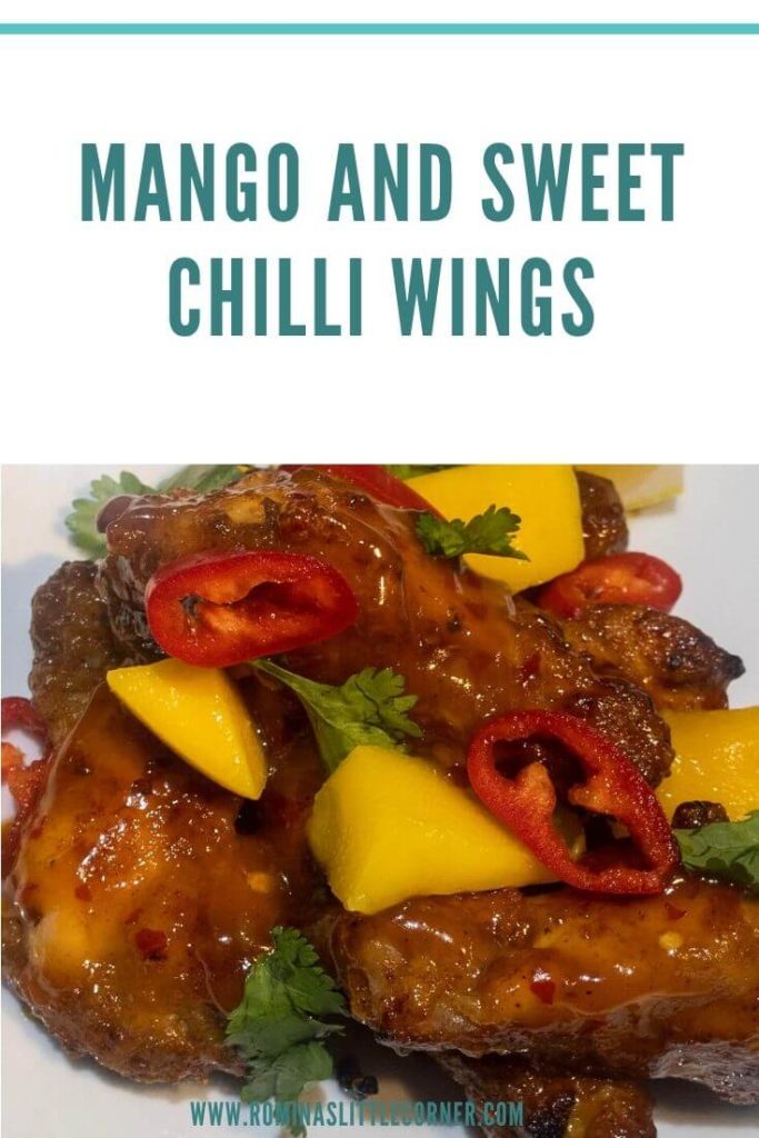 Mango and sweet chilli wings garnished with mango pieces, chillies and coriander leaves