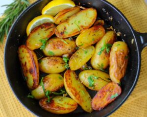 Lemon Balm and Garlic Potatoes in a cast iron pan